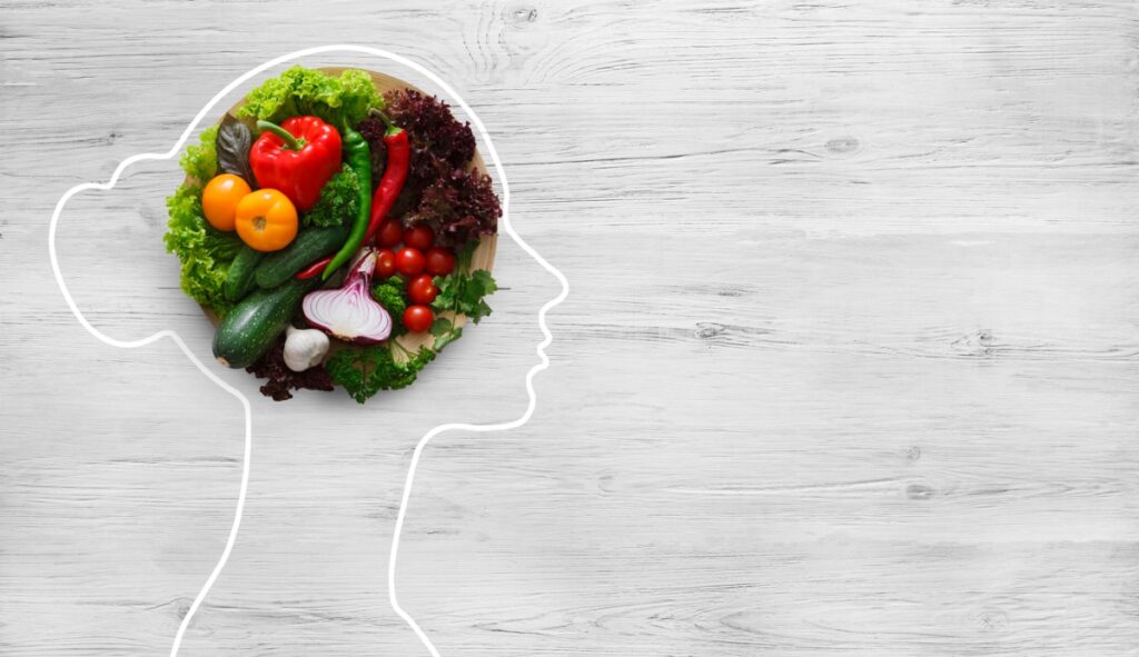 Outline of a woman with vegetables as the brain