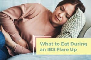 Woman clutching her stomach in pain during an IBS flare up